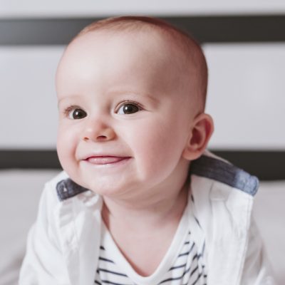 close up portrait of baby boy on bed. Family concept