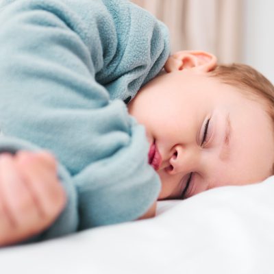 Sleeping peacefully. Shot of an adorable baby boy sleeping on a bed